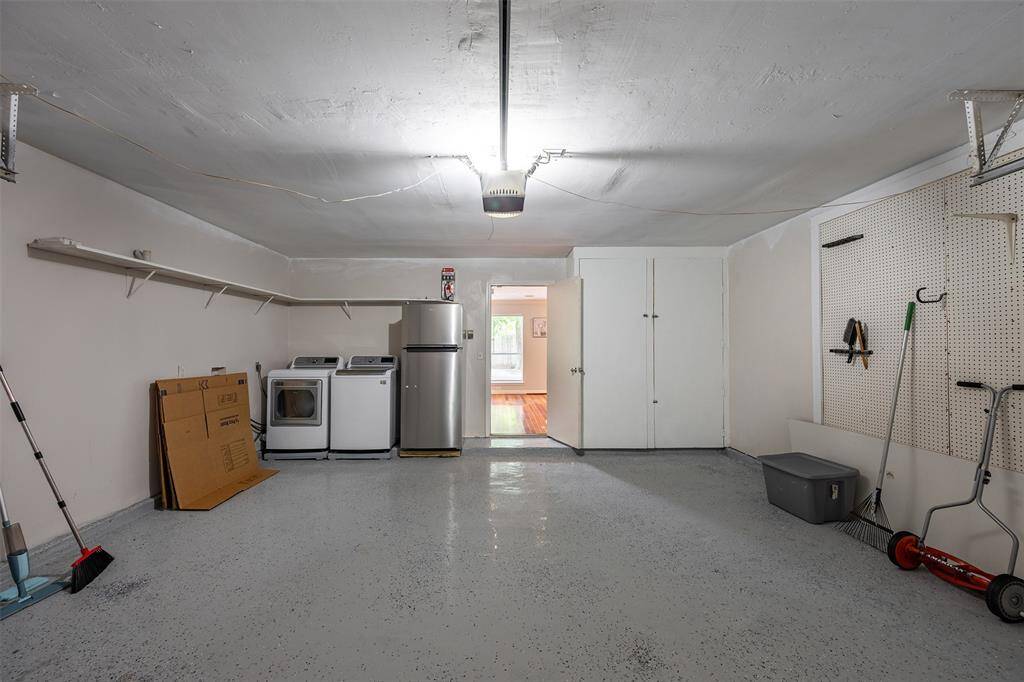 Upgraded garage with epoxy floors and extra storage space.
