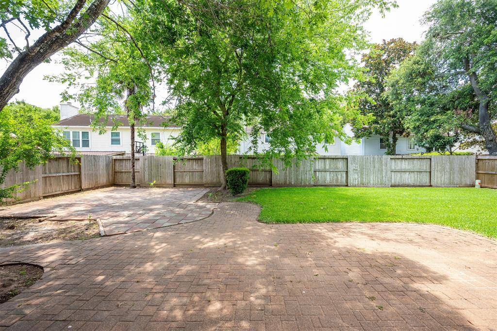 Spacious backyard with paved patio - perfect for entertaining or unwinding.