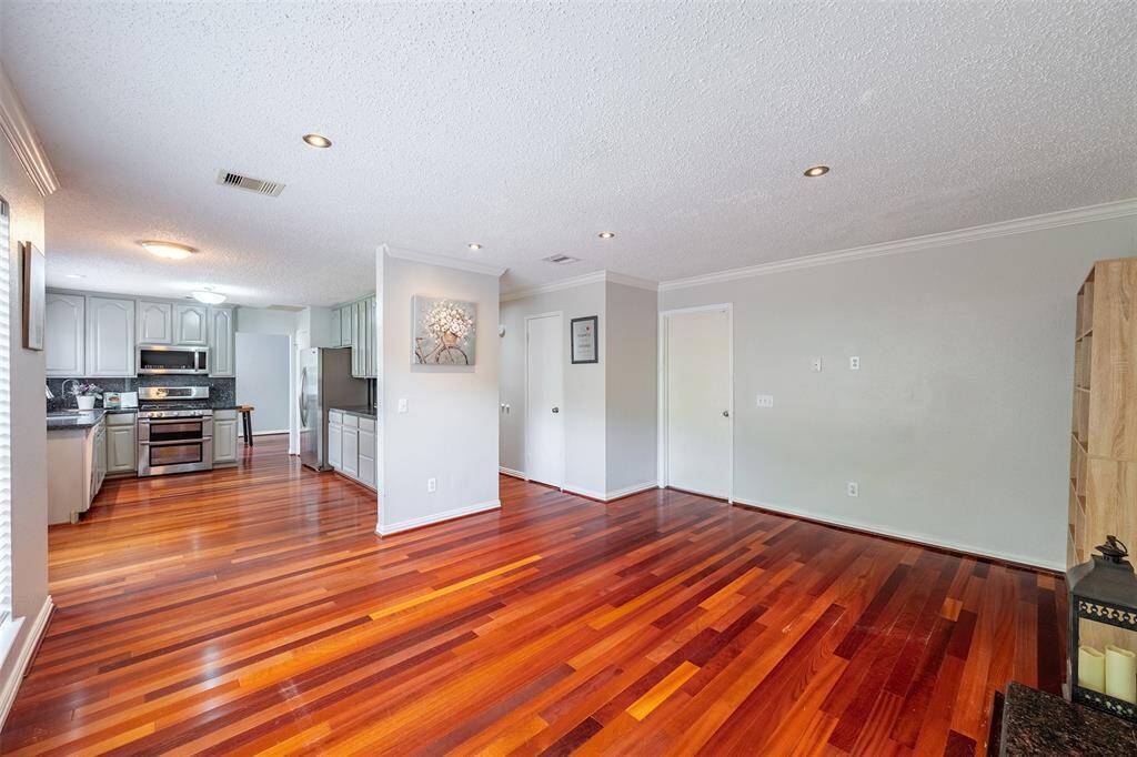 Neutral walls and warm hardwood floors flow through the open layout, making the whole space feel connected and inviting.