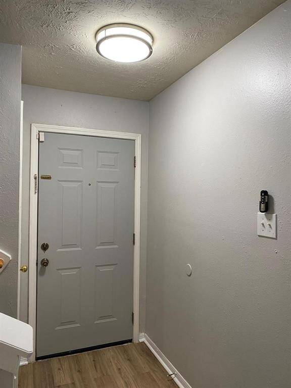 This is a two-story home with a clean exterior, featuring a combination of brick and siding. It has a two-car garage and a well-maintained front lawn. The driveway and walkway are paved, and the property is situated in a suburban neighborhood.