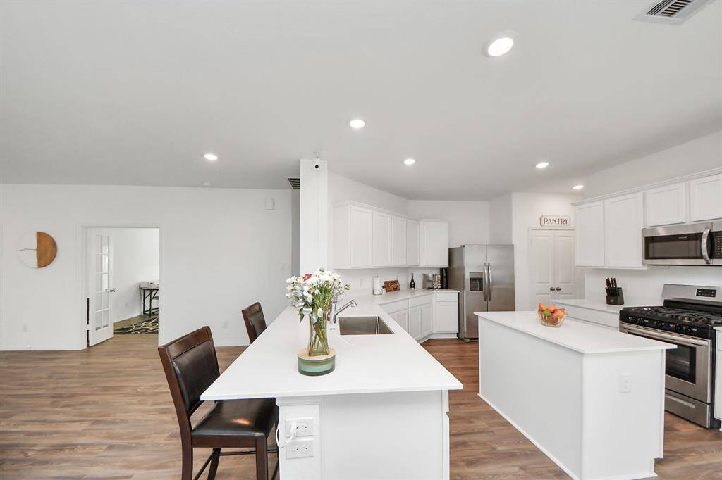 Kitchen open to living space with seating for easy entertaining.