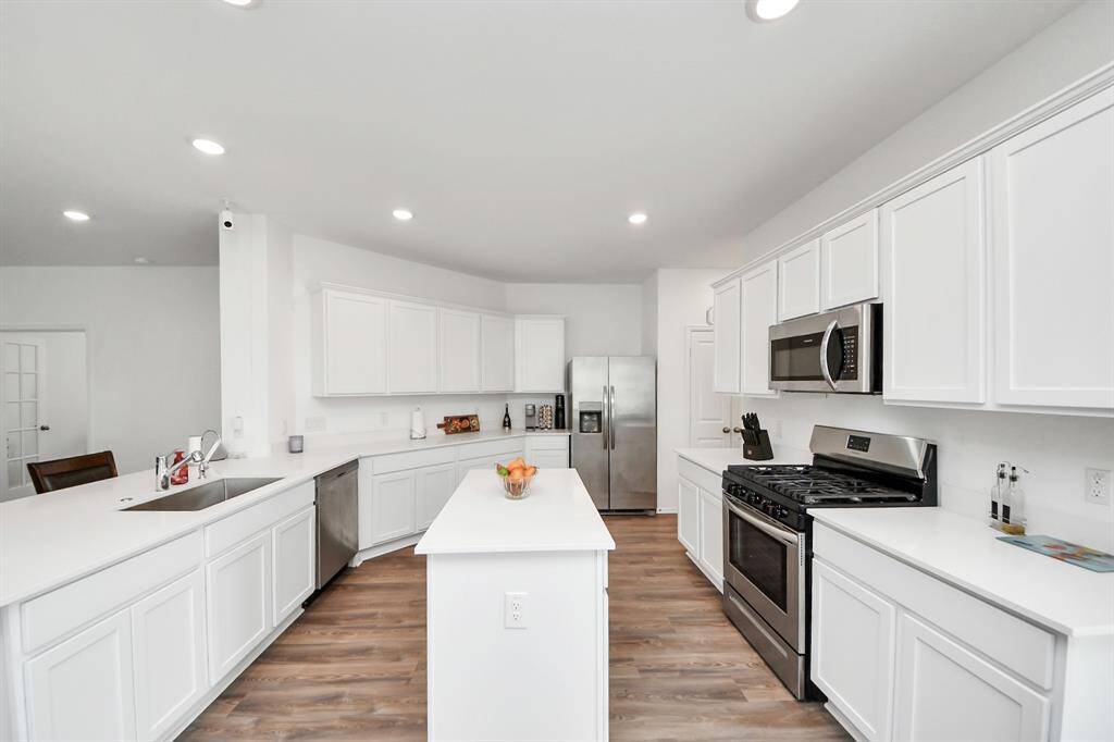 Beautiful white cabinetry with stainless steel appliances.