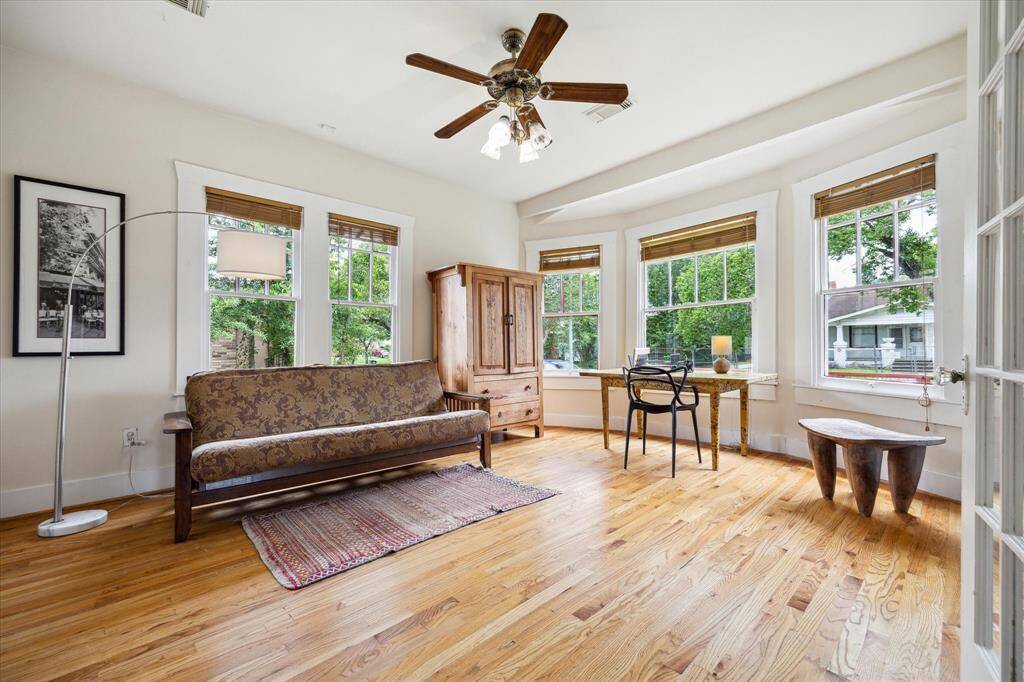 The first bedroom overlooks the front yard and includes its own ensuite bathroom, with double glass doors that open to the living room