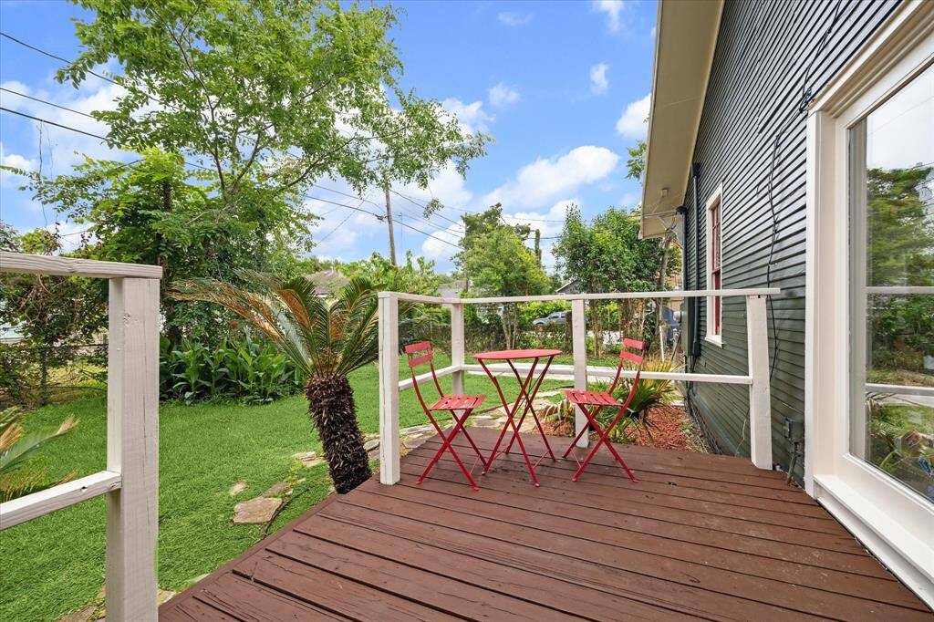 Step out onto this inviting back deck, perfect for morning coffee or watching your pets play.  Lush greenery surrounds this space.