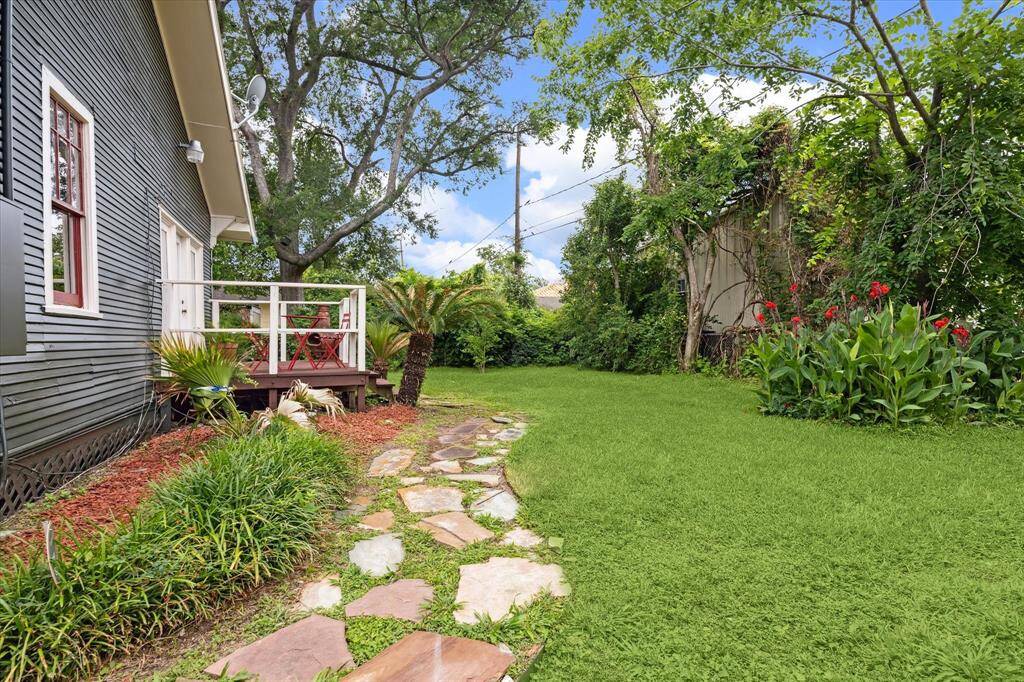 This lush backyard offers the perfect space for gardening, play or weekend entertaining under the trees.