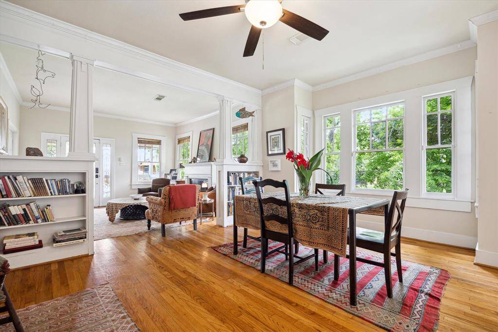 The dining room located between the kitchen and living room offer beautiful treetop views from the original windows.