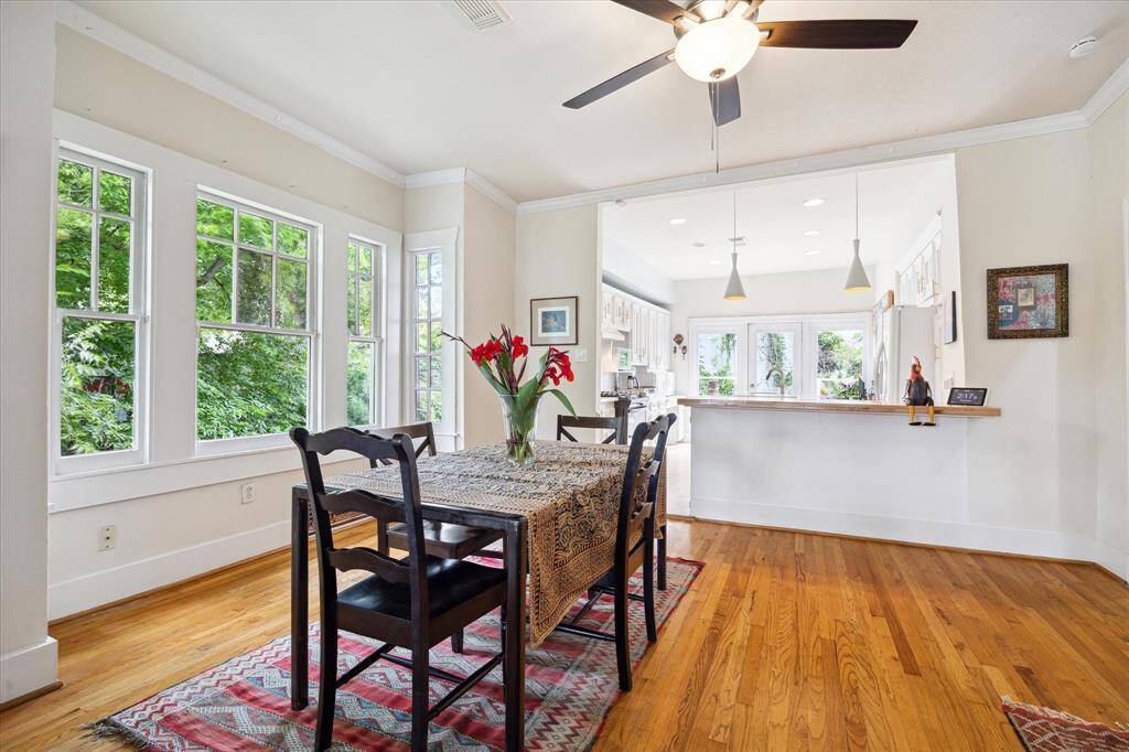 Gorgeous dining room with original hardwood floors and a breakfast bar - perfect for gatherings!