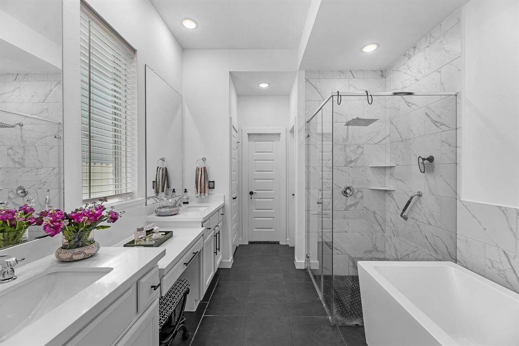 Primary bath features a soaking tub and separate shower with the wonderful Rainfall Shower Head.