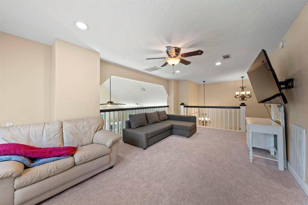 The game room offers lots of natural light and overlooks into the living area.