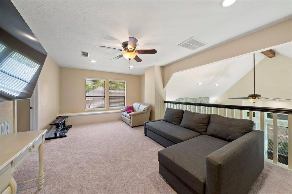 Another view of the game room with extra seating and extra storage by the double paned windows.