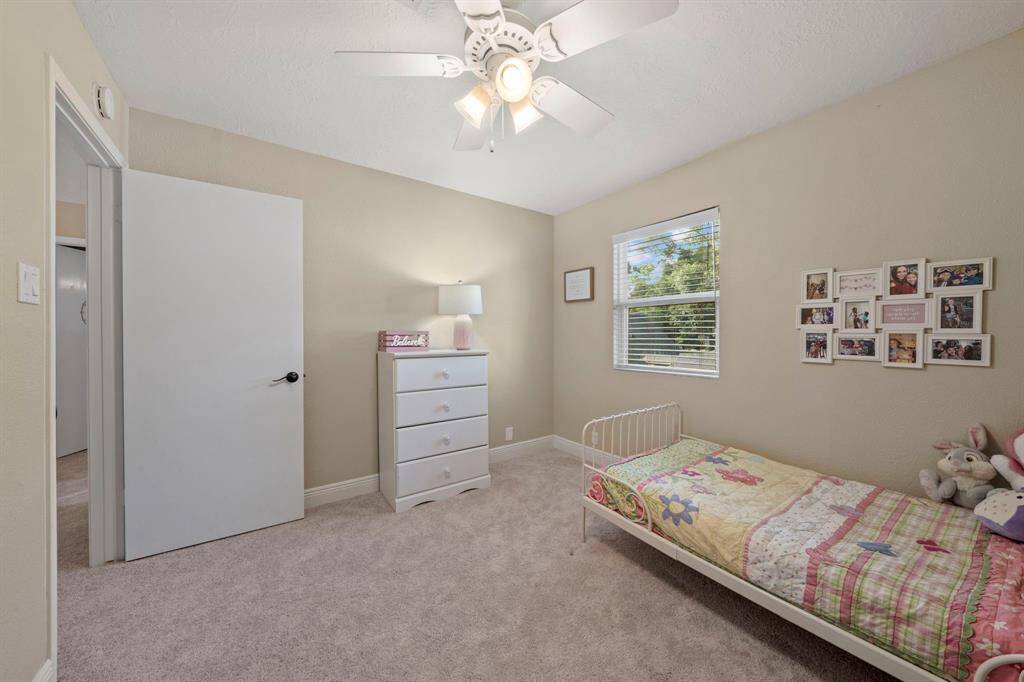 Third bedroom is very spacious and includes a ceiling fan, walk-in closet and new carpet - while the double paned window provides natural light.
