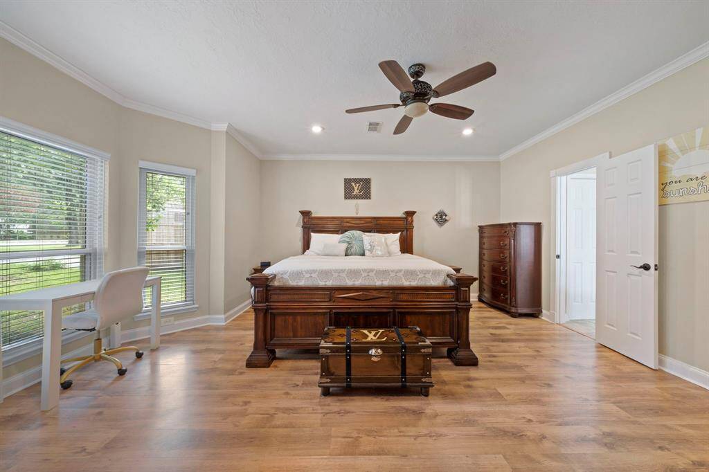 Primary bedroom is huge and features a cozy nook and ceiling fan.
