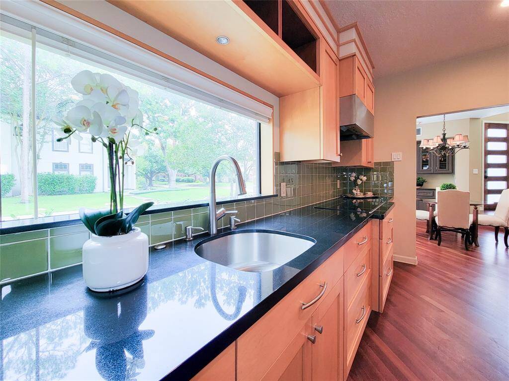 Wet bar and long side cabinets and countertops serve as a butler's pantry off the dining room.