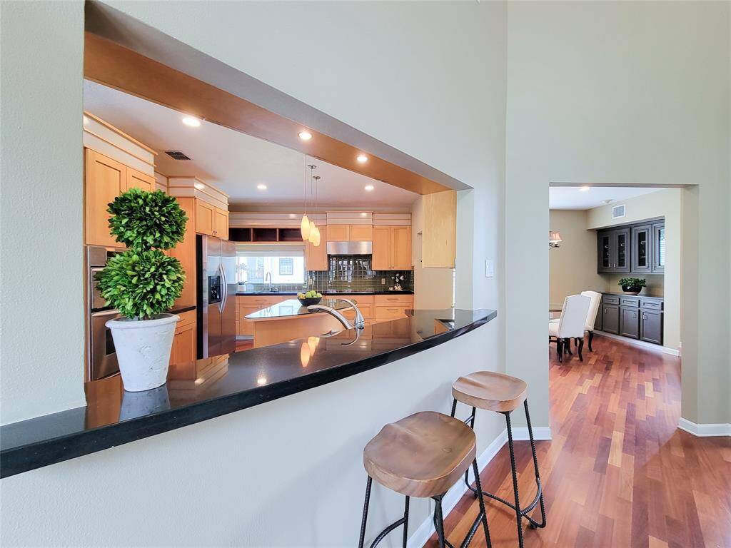 This breakfast bar effortlessly transitions into the inviting living space, creating a perfect flow for modern living."