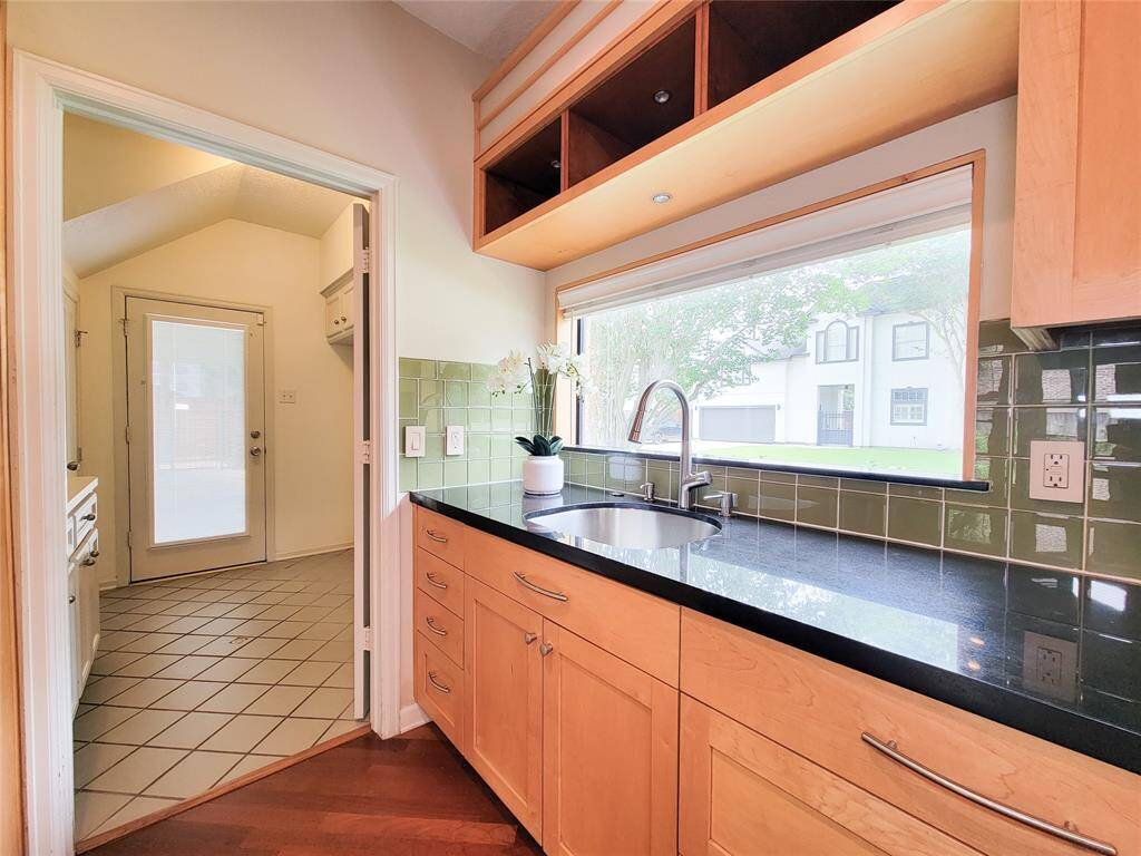 At the end of the butler's pantry/extra cabinets, is the laundry and mud room. The side door leads out to the two car, side loading garage.
