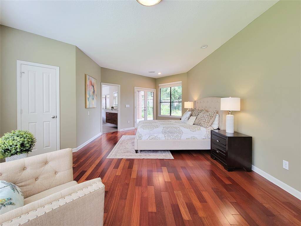 Step into luxury with this downstairs primary suite, featuring elegant French doors that open to your private patio retreat. A perfect blend of indoor comfort and outdoor charm!