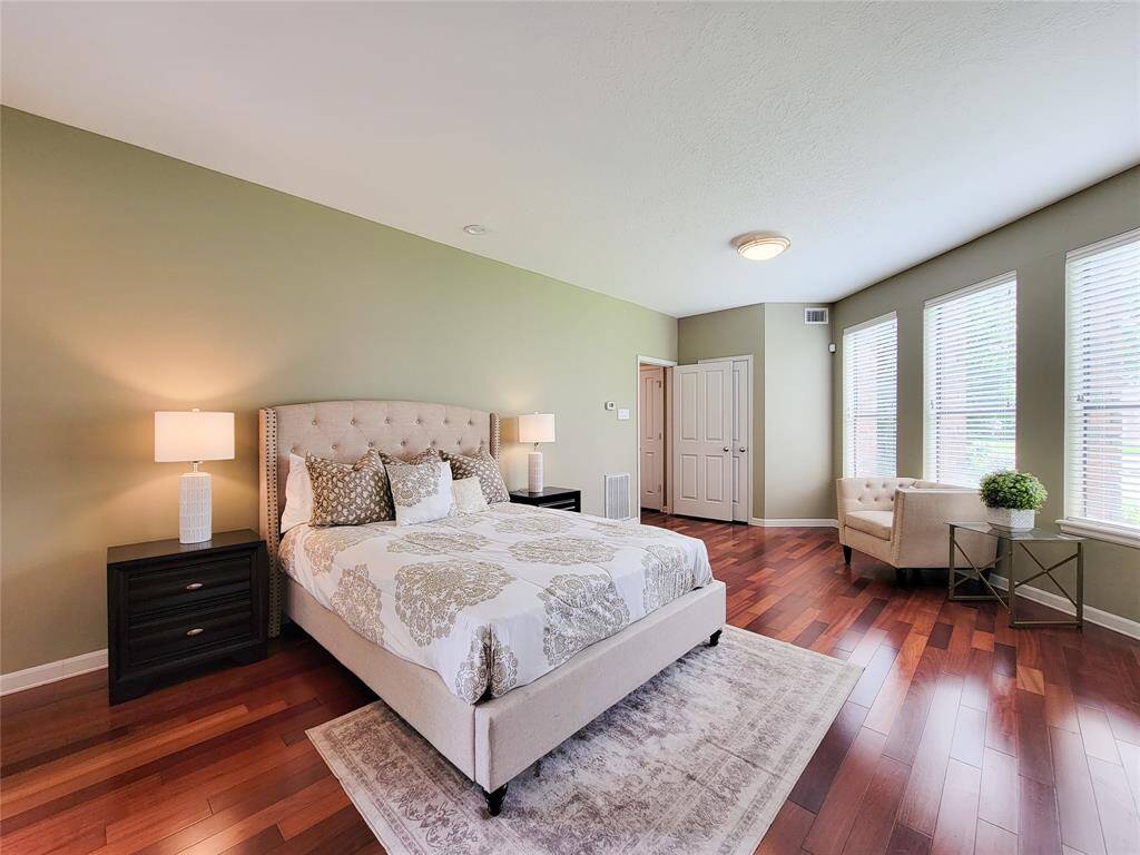 Owner's suite has two walk-in closets and French doors leading to one of the many covered backyard patios.