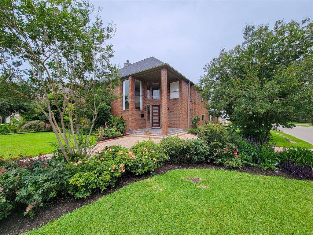 Gorgeous landscaping with zoned sprinkler system and circular driveway.