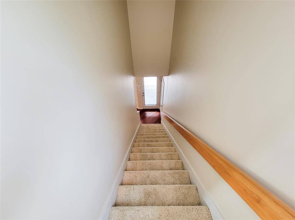 A convenient second stairway tucked behind the kitchen and beside the downstairs study, offering easy access and thoughtful design for seamless flow throughout the home.