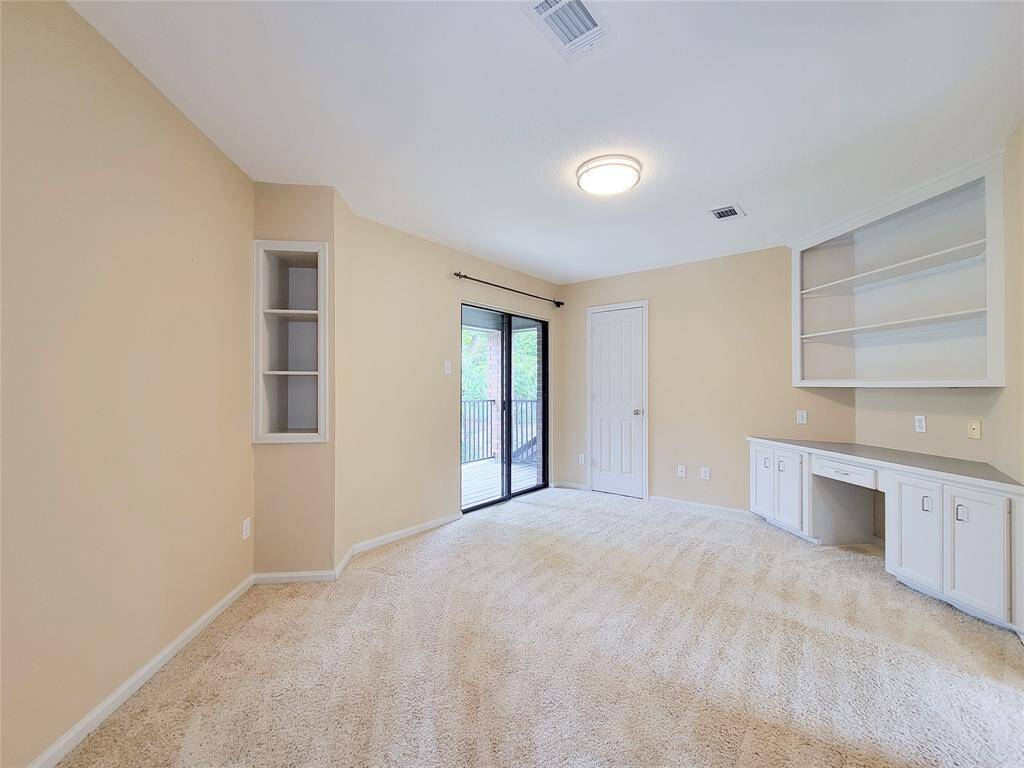 The first of the secondary bedrooms has a built-in desk and shelves, walk in closet and patio doors leading to private balcony.