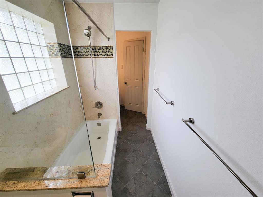 The shared tub and shower is between the two Jack and Jill vanities.