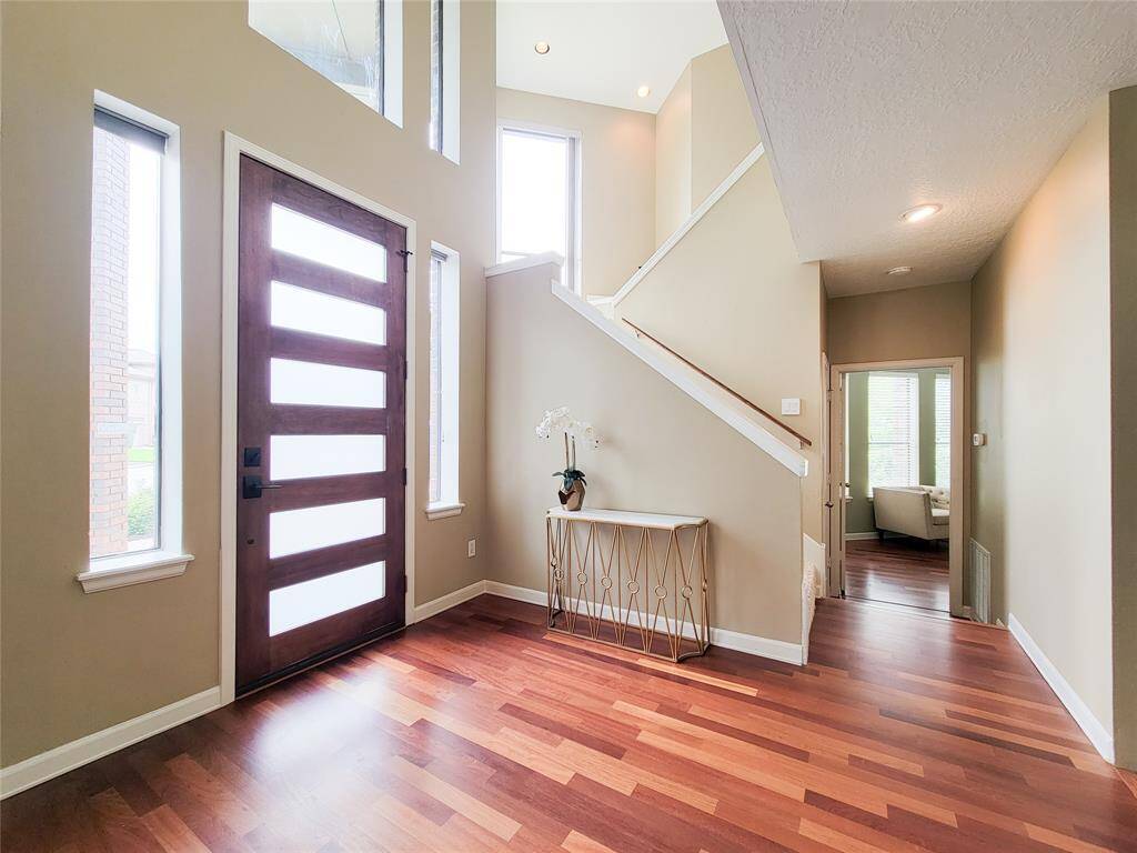 Welcome home! Walk through the eight-foot mahogany front door into the foyer. Engineered cherrywood flooring high ceilings.