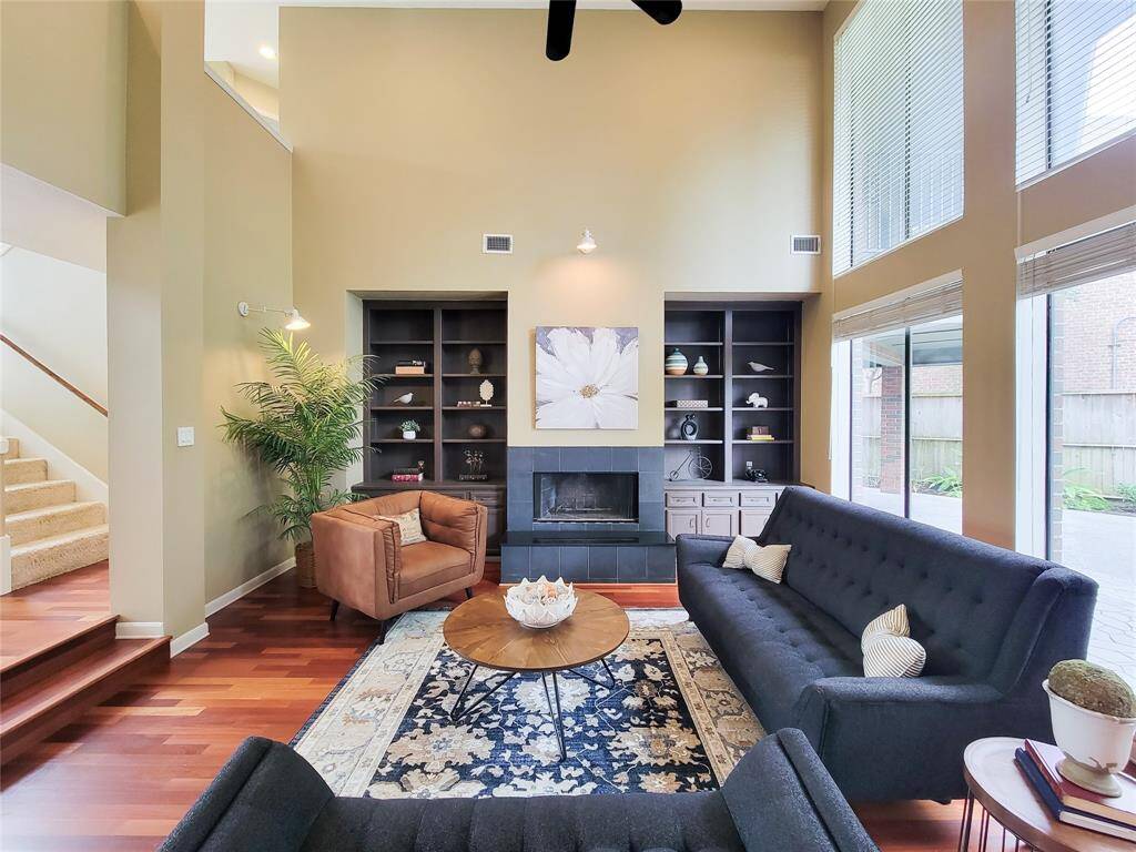 Elegant living meets cozy ambiance—this stunning living room features a gas fireplace framed in luxurious granite, creating the perfect focal point for relaxation and style."