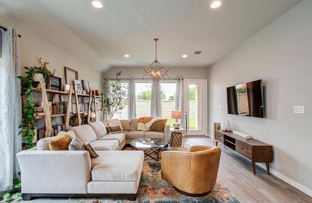 Retreat to the serene primary suite, where a wall of windows provides tranquil views of the backyard. The suite offers ample space and a peaceful ambiance for ultimate relaxation.