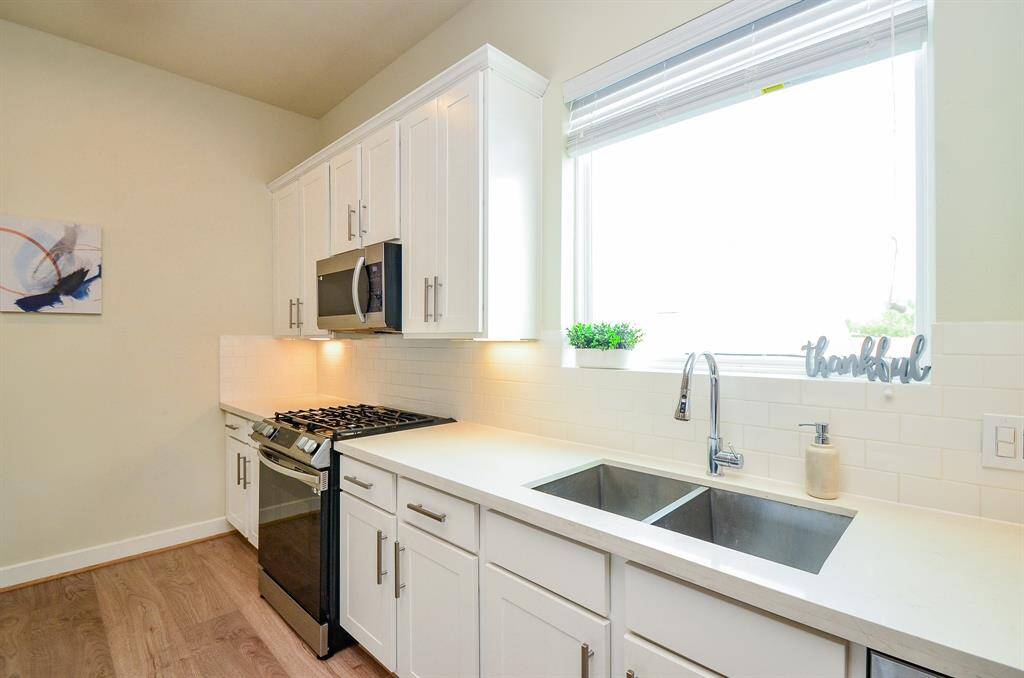 Dual stainless-steel sinks, under pure natural light, atop great storage below, is a winning feature.