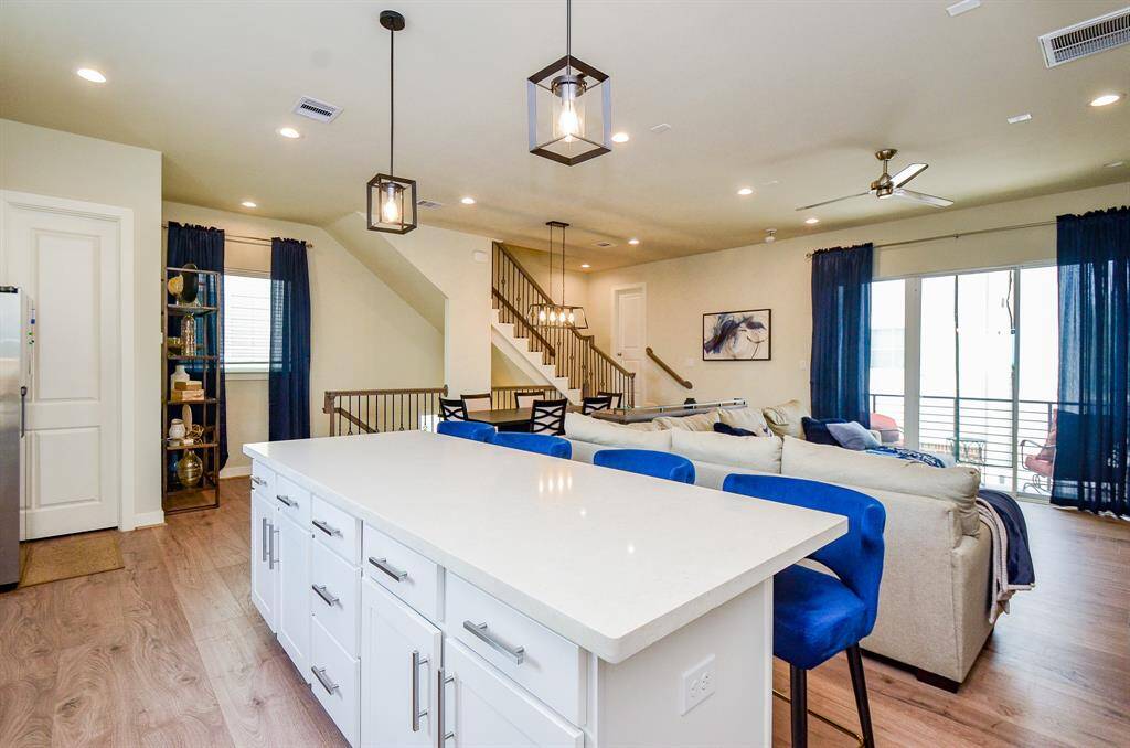 Now, here's the timeless beauty of the open floor plan design concept in full bloom! The seamless bonding of the most traveled common areas of the home is pictured here, with generous living and kitchen areas comfortably served.