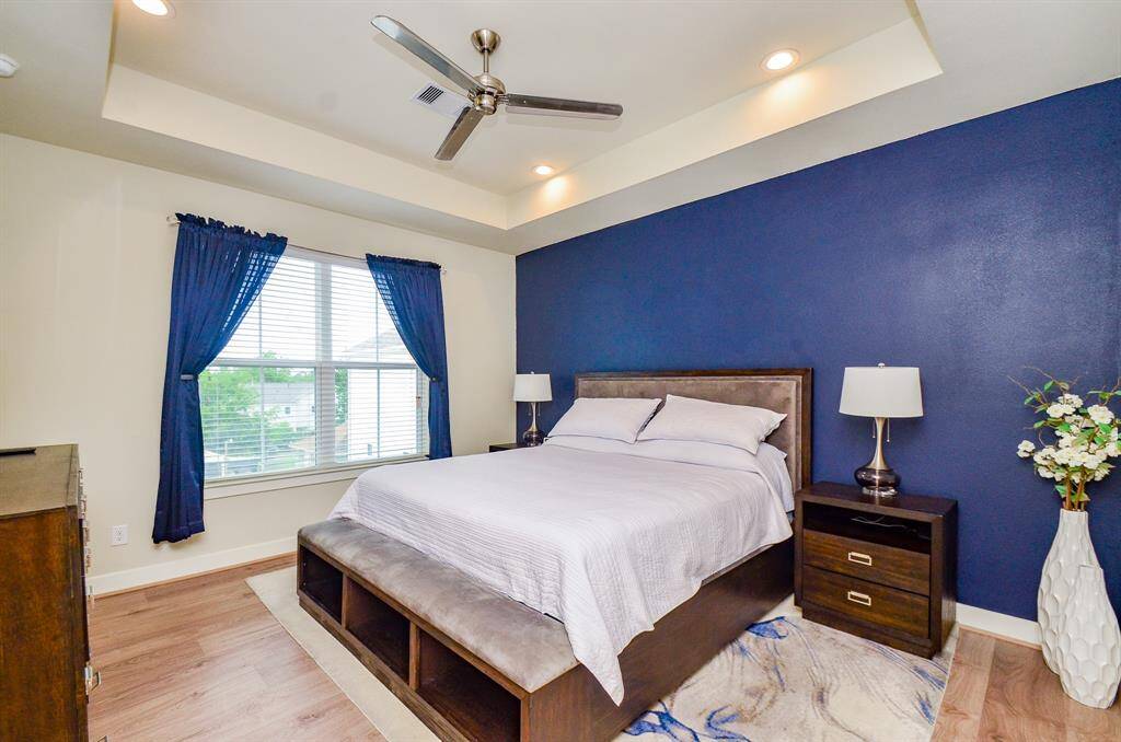 How luxurious! This heavenly primary suite, located on the 3rd floor, sits below an intimate tray ceiling, with a dynamic splash of color on long wall; pale tones on others, and gorgeous 'blond' Swiss wood flooring.