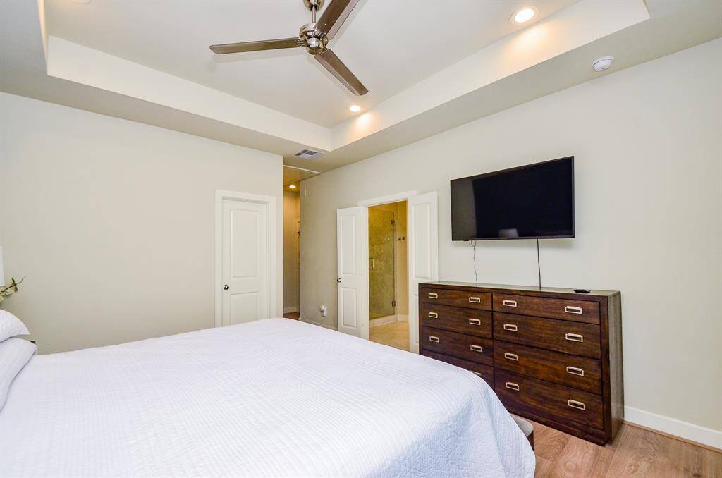The primary ensuite bath is beyond open double doors, right.