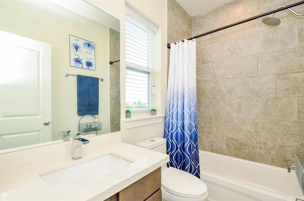 An ensuite bath on the third floor offers combined shower/bathtub, soothing pale tile surround, a large window and the same comforts of its bath counterparts!