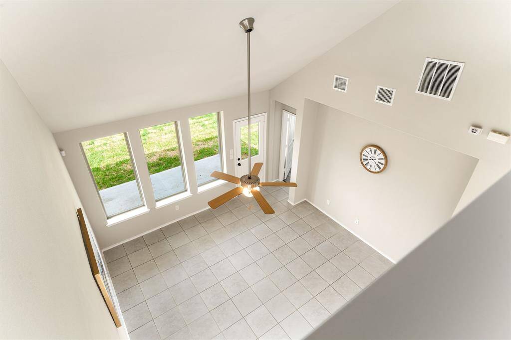 Bright and airy living room with soaring ceilings, large windows, and sleek tile floors for a modern touch