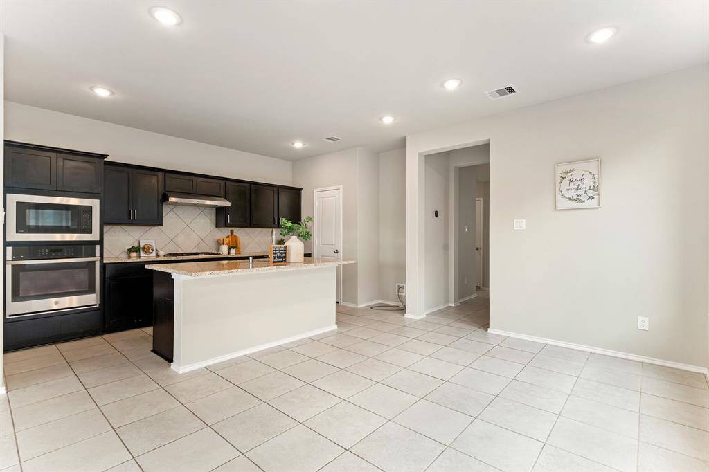The gourmet kitchen offers ample cabinetry, generous counters, stainless steel appliances