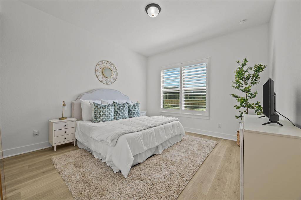 A private and spacious en-suite just off the front entrance offers total seclusion, featuring plantation shutters and serene lake views.