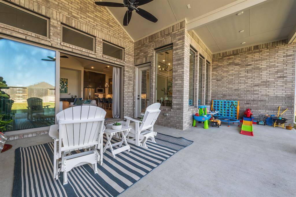 This extended covered patio also allows for seamless flow of indoor-outdoor entertaining through the sliding glass wall. There is plenty of room for any number of outdoor furniture options.