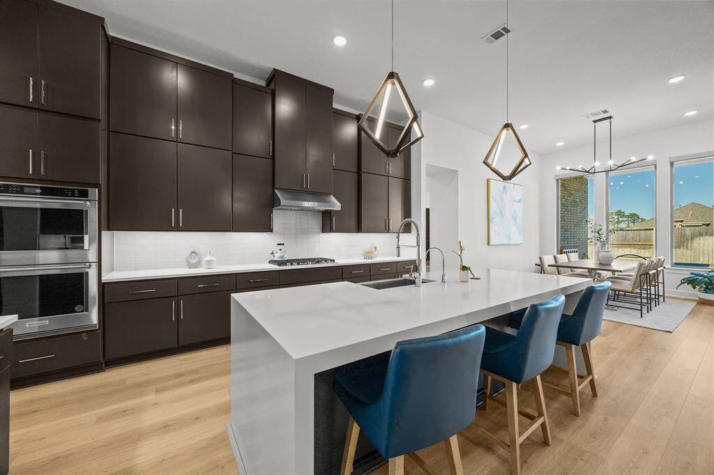 This chef inspired kitchen features a waterfall island with all of your tidy work combined in one location and a bonus feature of reverse osmosis water filtration.