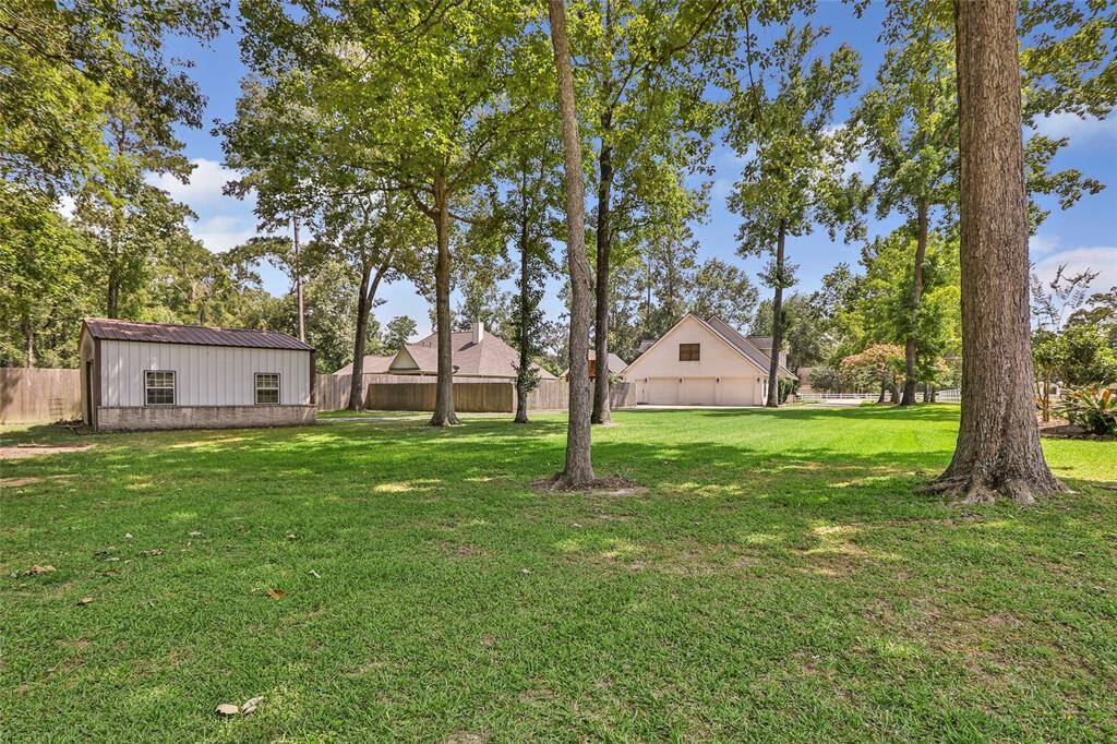 Embrace outdoor living with this expansive lot, surrounded by trees and featuring a shed for extra storage.