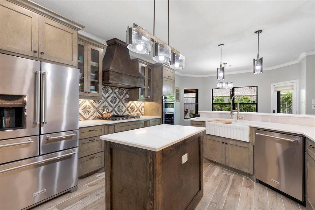 The large, inviting kitchen features a wine fridge, expansive island, and high-end finishes for culinary enthusiasts.