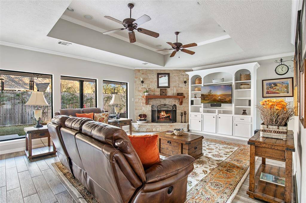 This living room is ideal for the day to day - large, recessed ceilings, beautiful fireplace with a wood mantle, and room for all your furniture.