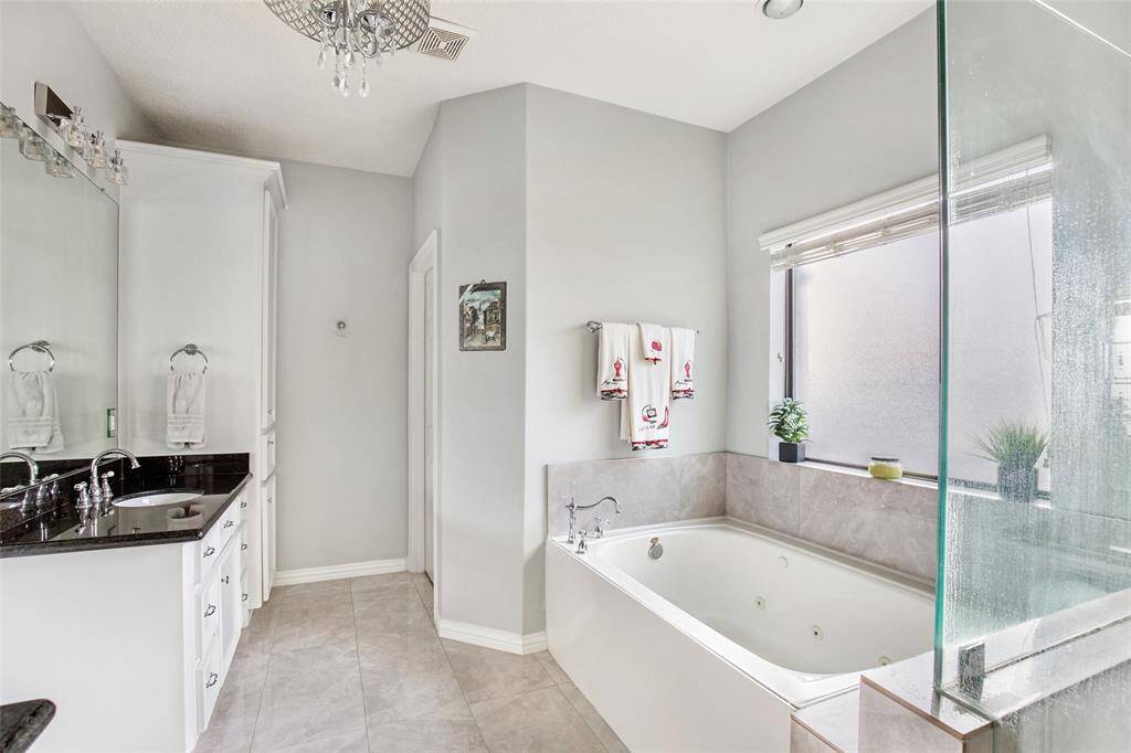Lots of storage in this bathroom! Relax after  a long day in the garden soaking tub.