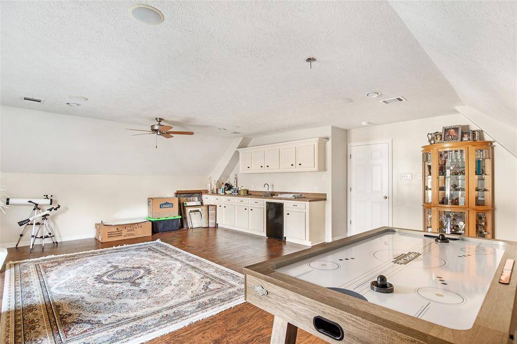 Endless fun awaits in this game room with an air hockey table, telescope, and plenty of space for entertainment.