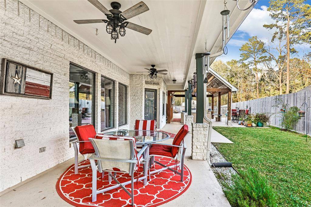This oversized patio has room for multiple tables and furniture setups. Enjoy the beautiful summer in this spacious backyard!