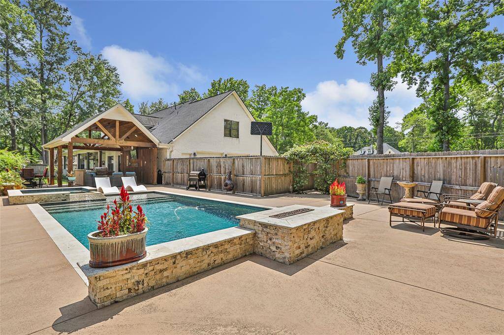 Have the ultimate summer swim party in your new pool with a waterfall feature and oversized hot tub.
