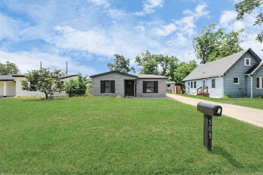Charming single-story home with a modern facade, situated on a spacious, well-maintained lawn. Features a long driveway and a prominent mailbox. Ideal for those seeking a cozy, suburban setting.