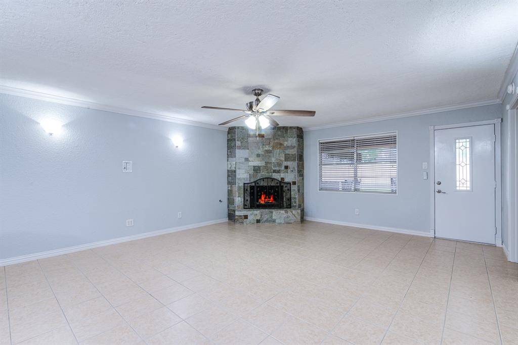Cozy up in style with this beautifully updated fireplace, featuring stonework that adds warmth and charm to any living space.