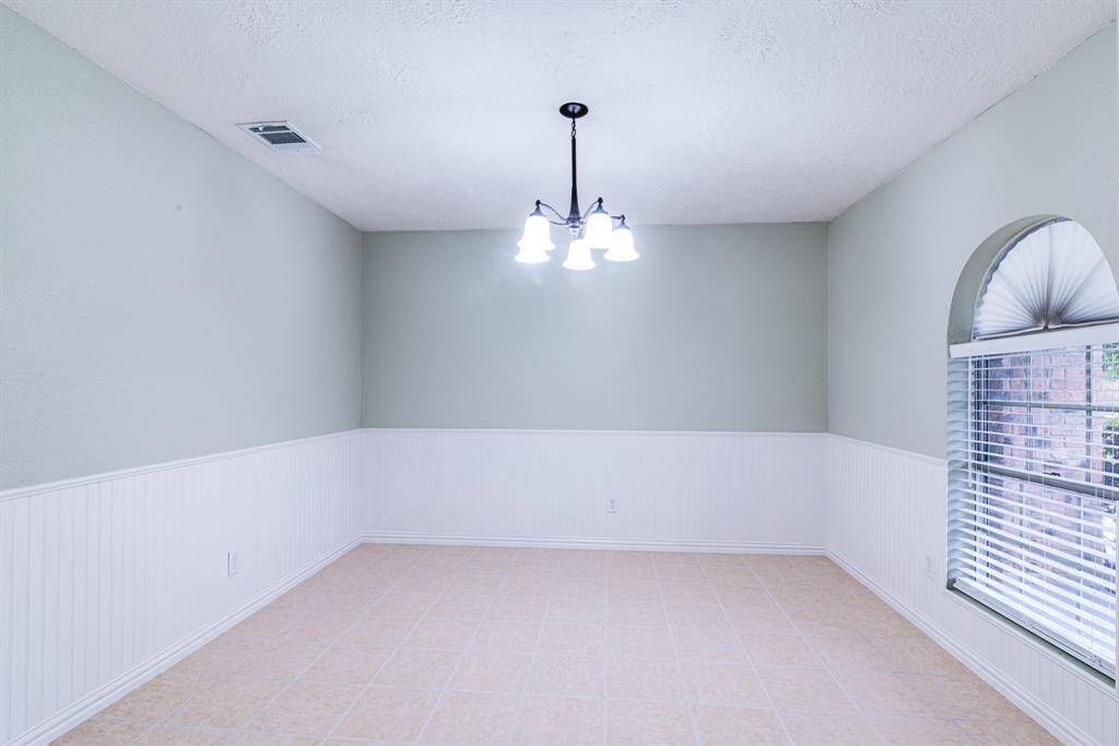 Formal dining room featuring wainscoting and fresh paint