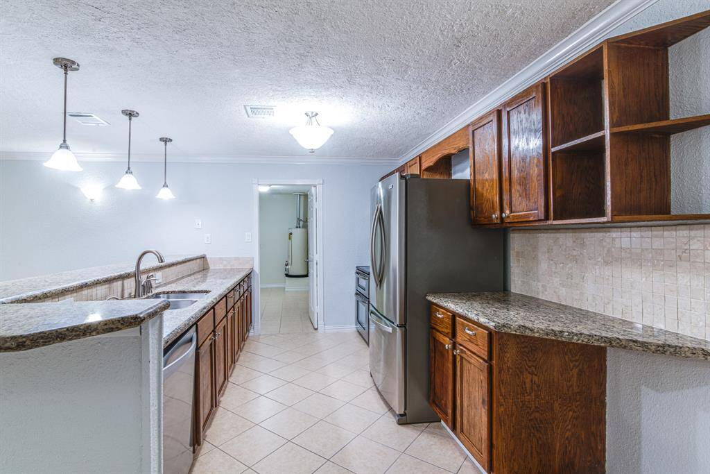 Kitchen offers stainless steel appliances, granite countertops and storage.