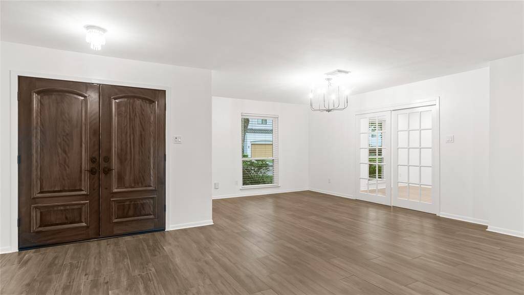 The solid wood double doors open to the dining, living and kitchen area.